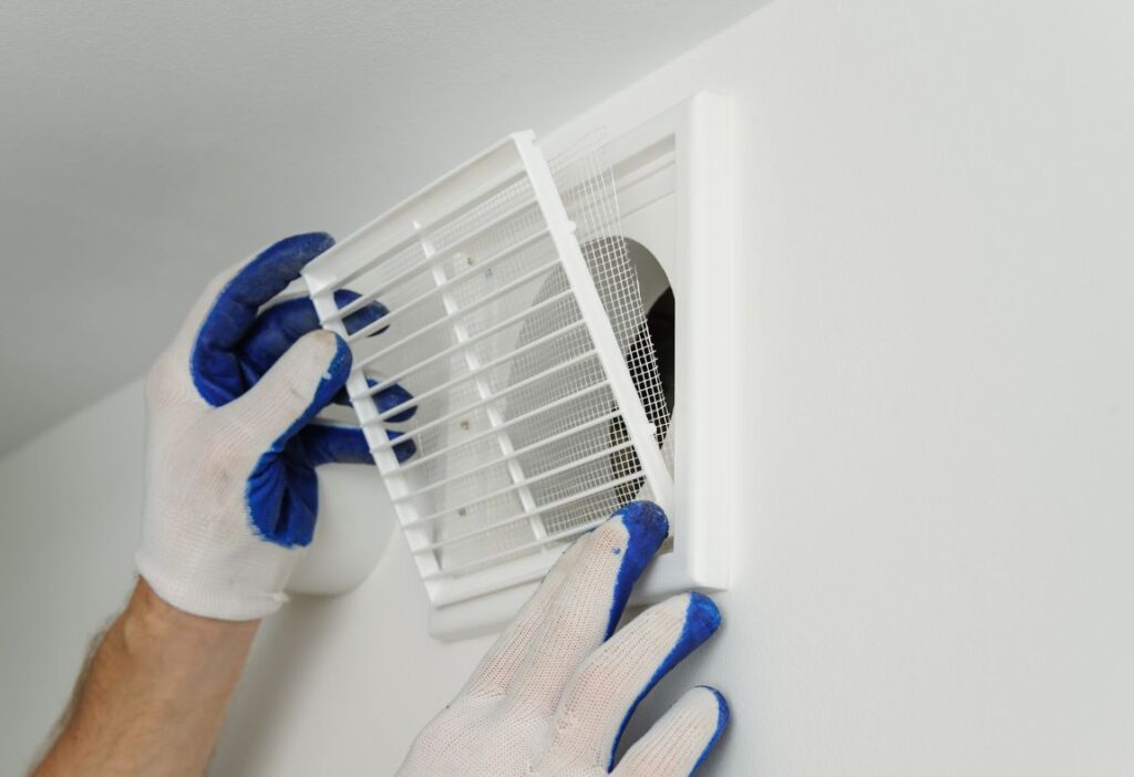 a person wearing gloves holding a vent