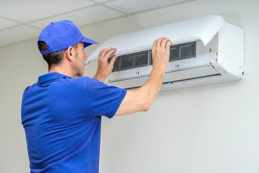 A man inspecting mold in HVAC systems.